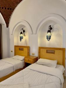 Postel nebo postele na pokoji v ubytování Hotel Sheherazade Luxor