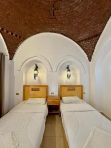 Postel nebo postele na pokoji v ubytování Hotel Sheherazade Luxor