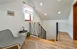 a living room with a chair and a staircase at Nice Home In Sedlarica With Sauna in Sedlarica +50 photos