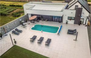 an overhead view of a swimming pool with lounge chairs at Awesome Home In Koritna With Sauna in Koritna +36 photos