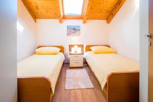 two beds in a small room with a window at Villa Vita in Polje +25 photos