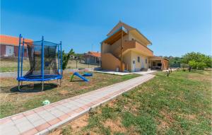 a house with a basketball hoop in front of a house at 4 Bedroom Stunning Home In Polaca in Polača +33 photos