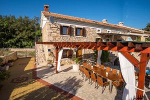 a patio with a table and chairs in front of a building at Villa Vita in Polje