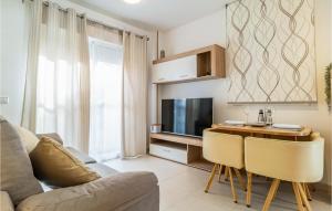 a living room with a couch and a table with a television at Charming Apartment With Pool in Vera
