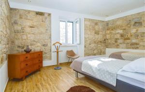オミシュにあるAmazing Home In Omis With Wifiのベッドルーム1室(ベッド1台、ドレッサー、椅子付)