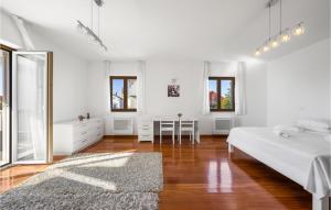 a white bedroom with a bed and a mirror at 4 Bedroom Cozy Home In Vodice in Vodice