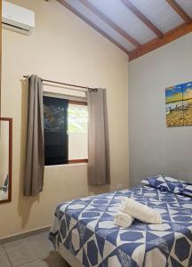 a bedroom with a bed with towels on it at Casa do Mar & Ane Ilhabela in Ilhabela