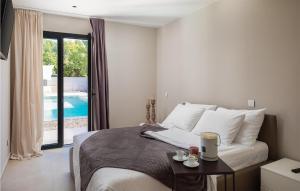 a bedroom with a bed and a view of a pool at Villa Viktoria in Pakoštane