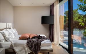 a bedroom with a bed and a tv and a window at Villa Viktoria in Pakoštane +28 photos