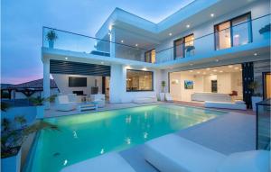 a house with a swimming pool in front of it at Villa Michelle in Maslenica