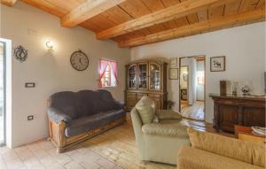 a living room with a couch and a chair at Amazing Home In Novi Vinodolski in Novi Vinodolski