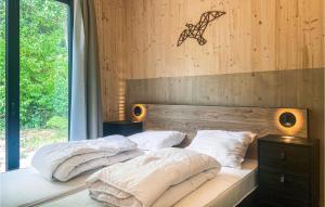 a bedroom with two beds and a window at Awesome Stacaravan In Callantsoog in Callantsoog