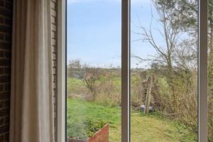 a window with a view of a field at Cozy Holiday Home In Thisted in Thisted