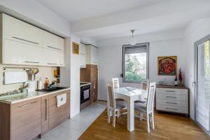 a kitchen with a table and a table and chairs at Skopje&Joy Central Flat in Skopje