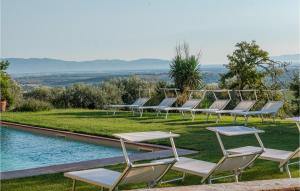 a row of lounge chairs next to a pool at Tenuta San Crescenzio in Magliano in Toscana +49 photos