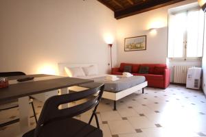 a room with a bed and a table and a couch at Lovely studio in Campo de Fiori in Rome