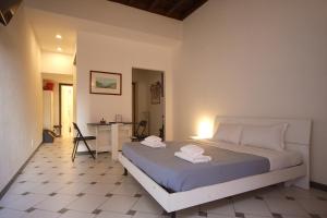 a bedroom with a bed with two towels on it at Lovely studio in Campo de Fiori in Rome