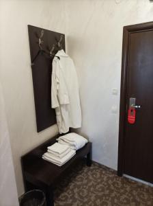 a room with a shelf with a pile of towels at Банско in Bansko +2 photos