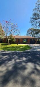 a parking lot in front of a building at Abbey Beach Cottage in Busselton