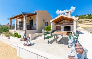 a house with a patio with a table and chairs at Holiday Home Neoric 2 in Neorić
