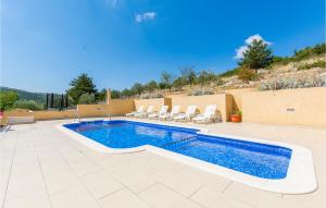 a swimming pool on a patio with chairs around it at Holiday Home Neoric 2 in Neorić