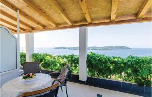 a table with a bowl of fruit sitting on top of a balcony at Apartment Na Krstu Vi in Orasac