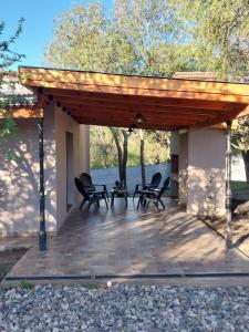 a pavilion with chairs and a table on a patio at Altos de Las Sierras in Cosquín +13 photos