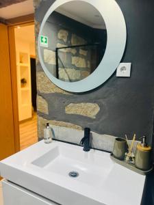 a bathroom with a sink and a mirror at Casa da Grota do Bravo in Nordeste +36 photos