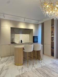 a kitchen with a table and two stools at Vanilla Studio in Timişoara