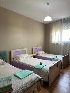 a room with two beds with green mats on them at Turdiu center apart in Tirana