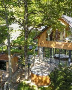 a tree house with a bench in the yard at Forest eco-house & spa in Dolenja Ravan +23 photos