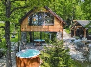 a log house with a pool in the yard at Forest eco-house & spa in Dolenja Ravan