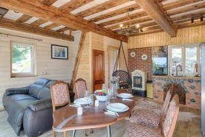 a living room with a table and a couch at Forest eco-house & spa in Dolenja Ravan