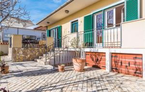 a house with a patio and a fence at Amazing Home In Vrsi With Wifi in Vrsi +26 photos