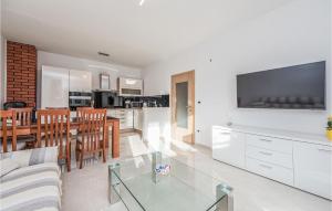 a kitchen and living room with a glass table at Amazing Home In Vrsi With Wifi in Vrsi