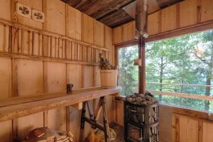 a log cabin with a counter and a window at Forest eco-house & spa in Dolenja Ravan