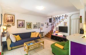 a living room with a blue couch and a tv at Holiday Home Sucuraj 06 in Sućuraj