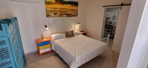 a small bedroom with a bed and a night stand at Casa Tabaiba in Parque Holandes +12 photos