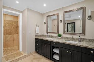 a bathroom with two sinks and a shower at Chic Princeville Villa Private Pool Relaxation and AC in Princeville +21 photos