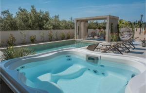 a swimming pool with a jacuzzi in a backyard at Villa Utopia in Ugljan