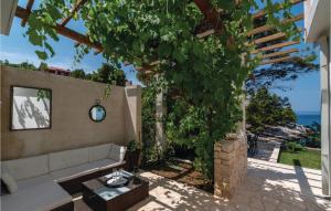a living room with a couch and a tree at Amazing Home In Blato With Wifi in Blato
