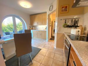 a large kitchen with a counter and an archway at Frische Brise in Schönberger Strand +7 photos