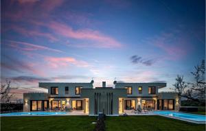 a large house with a pool at dusk at Villa Estate in Brtonigla
