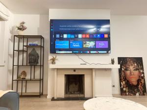 a living room with a flat screen tv above a fireplace at Charming two bedroom flat - NATO - Brussels in Brussels +12 photos