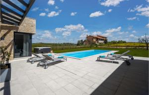 a swimming pool with chaise lounge chairs and a swimming pool at Villa Estate in Brtonigla +36 photos
