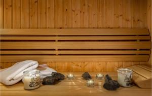 a sauna with candles and towels and rocks on a table at Villa David in Rab