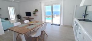 a kitchen and dining room with a table and chairs at Casa Bincoblanco, balcony of the Atlantic in Guía de Isora