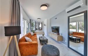 a living room with a couch and a tv at Lovely Home In Seget Donji in Trogir
