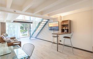 a living room with a table and chairs and a staircase at Prora Solitaire Avida Loft 4 in Binz +35 photos