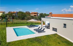 a backyard with a swimming pool with chairs and a playground at Villa Lia in Vintijan
